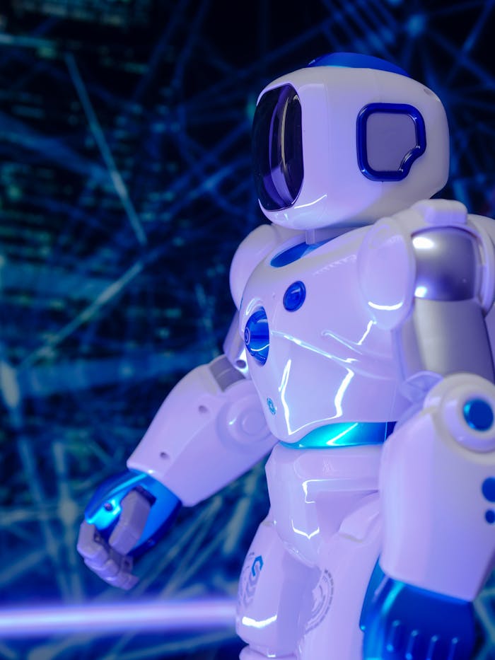 Close-up of a modern humanoid robot with glowing blue lights and futuristic design.